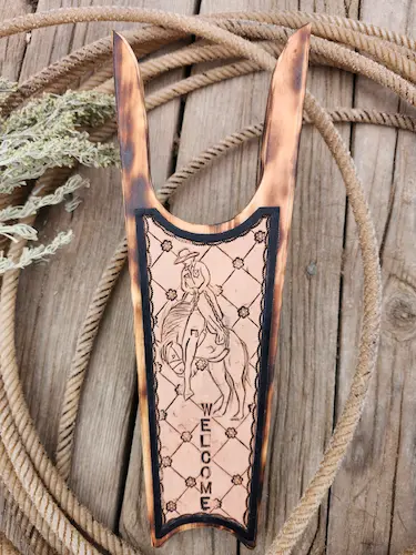 Handmade wooden boot remover with handtooled leather design