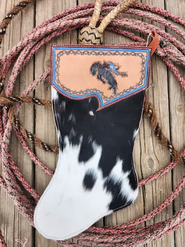 Handtooled leather stocking: bucking bronc